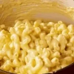 stirring macaroni and cheese