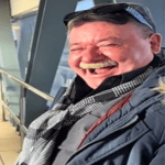 Guy laughing at whistle (at the airport)